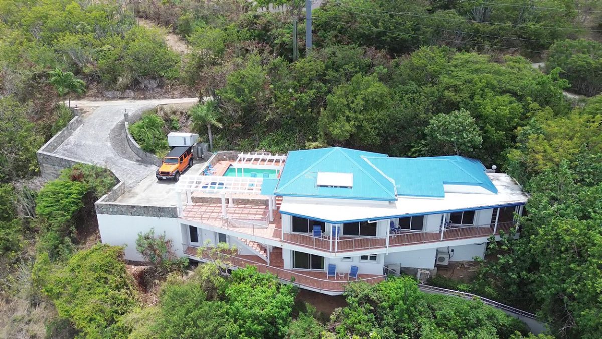 Aerial view of Dream Come True villa perched above Devers Bay, St. John, with pool and turquoise water