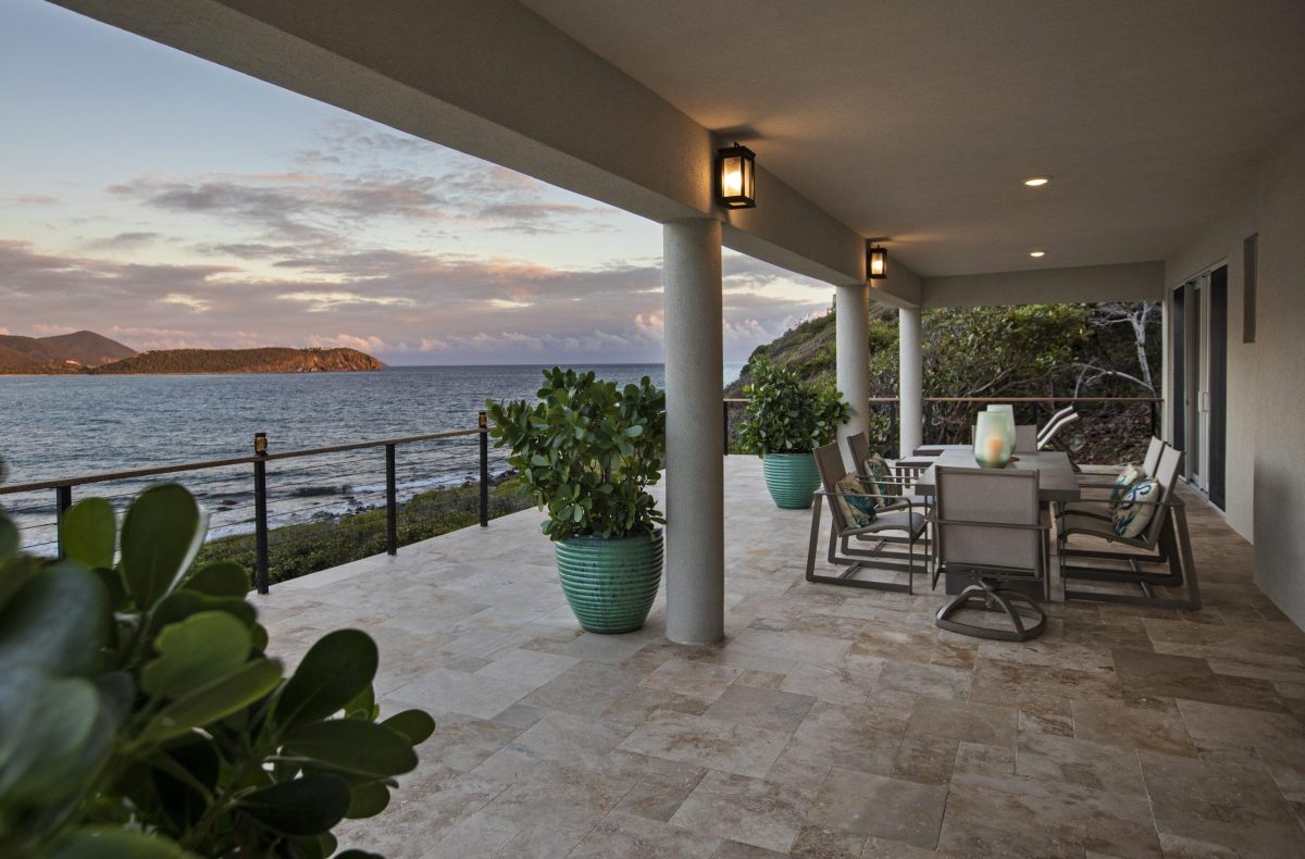 Hart Bay Beach House on its sand-and-stone beach at Hart Bay, Chocolate Hole, St. John, at sunset