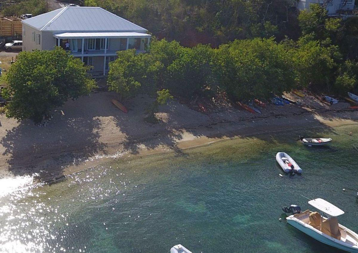 Aerial view of Shangri-La villa on the sandy beach at Chocolate Hole, St. John, with infinity pool